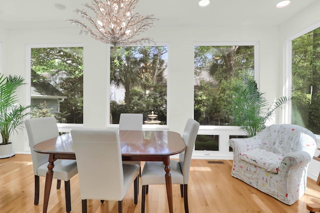 dining area featuring visible vents, recessed lighting, a chandelier, and wood finished floors