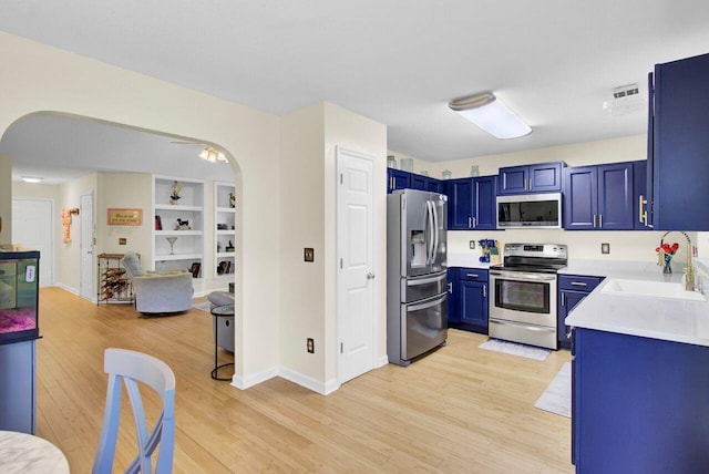 104 Lancaster Ct, Goose Creek, SC 29445 - kitchen with appliances with stainless steel finishes, blue cabinetry, light wood-type flooring, and light countertops