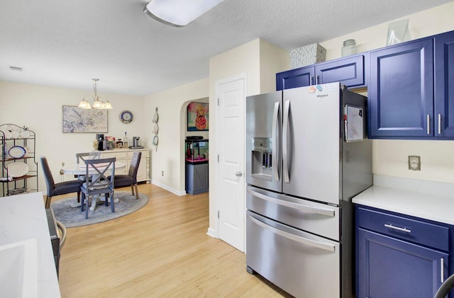 104 Lancaster Ct, Goose Creek, SC 29445 - kitchen featuring stainless steel fridge, blue cabinetry, light wood-type flooring, and light countertops