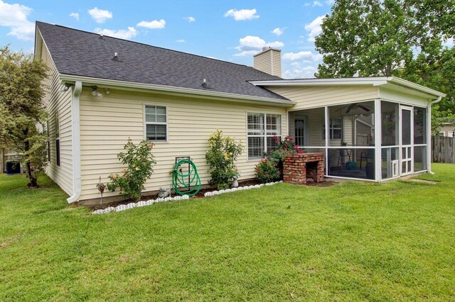 104 Lancaster Ct, Goose Creek, SC 29445 - rear view of house featuring a shingled roof, a chimney, a sunroom, and a yard