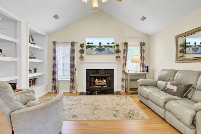 104 Lancaster Ct, Goose Creek, SC 29445 - living area featuring a ceiling fan, wood finished floors, vaulted ceiling, a high end fireplace, and healthy amount of natural light