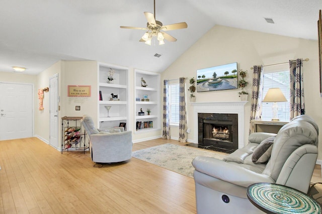 104 Lancaster Ct, Goose Creek, SC 29445 - living room featuring ceiling fan, light wood finished floors, a high end fireplace, built in shelves, and high vaulted ceiling