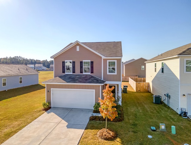 view of front of home with central AC, a garage, and a front lawn