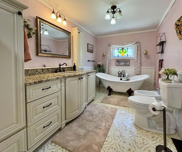 full bathroom featuring a wainscoted wall, a freestanding bath, toilet, vanity, and crown molding
