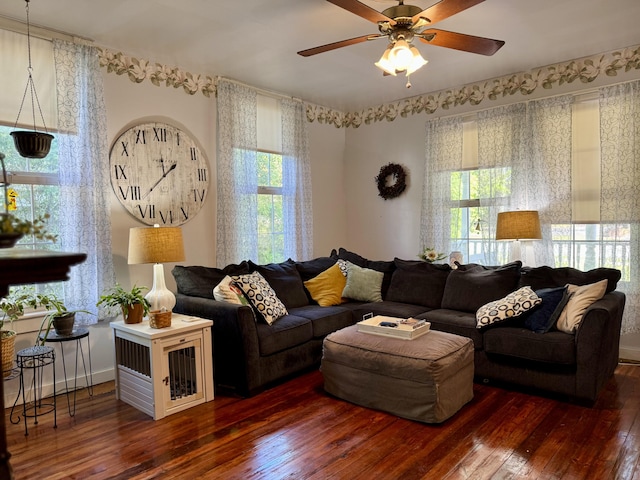 living room featuring wood-type flooring, a ceiling fan, and plenty of natural light