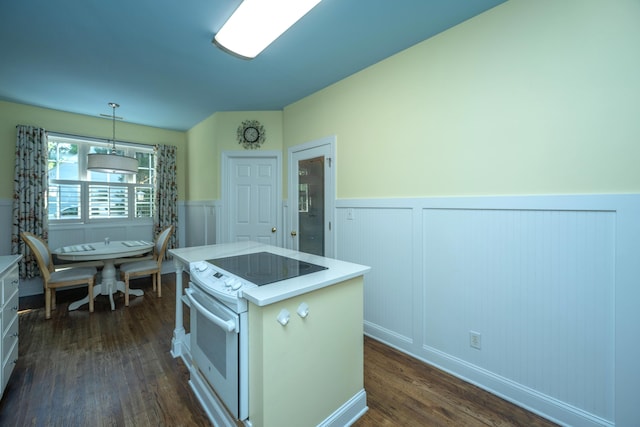 kitchen featuring pendant lighting, a kitchen island, white range with electric stovetop, and dark wood-type flooring