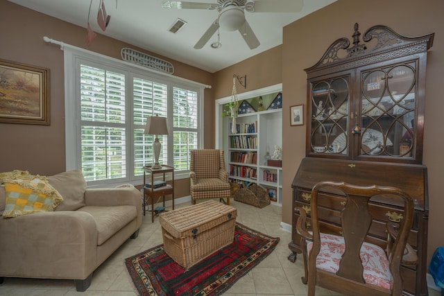 sitting room featuring light tile patterned floors, plenty of natural light, and ceiling fan