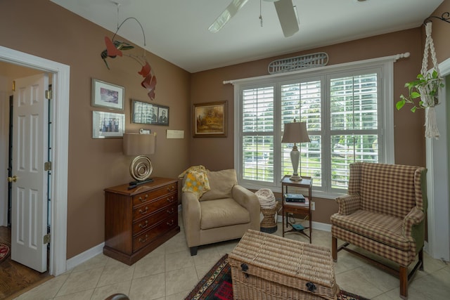 sitting room featuring ceiling fan and light tile patterned flooring