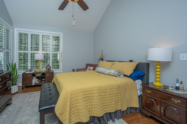 bedroom with ceiling fan, light hardwood / wood-style floors, and vaulted ceiling