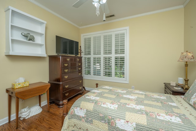 bedroom with ceiling fan, dark wood-type flooring, and ornamental molding