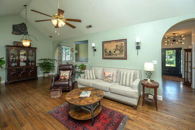 living room featuring hardwood / wood-style floors, ceiling fan with notable chandelier, and vaulted ceiling