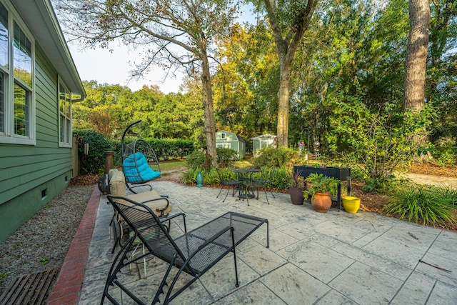 view of patio featuring a shed