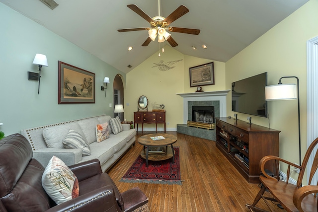 living room with a fireplace, lofted ceiling, ceiling fan, and dark wood-type flooring