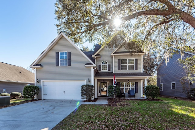 view of front property with covered porch, a garage, and a front lawn