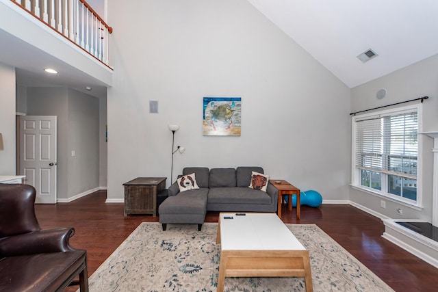 living room with high vaulted ceiling and dark wood-type flooring