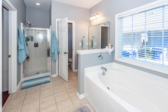 bathroom with tile patterned floors, independent shower and bath, and toilet