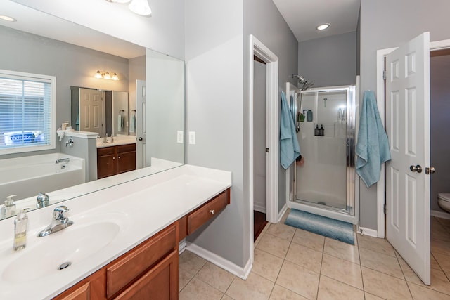 bathroom featuring tile patterned floors, vanity, and independent shower and bath