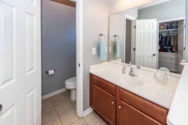 bathroom featuring tile patterned flooring, vanity, and toilet