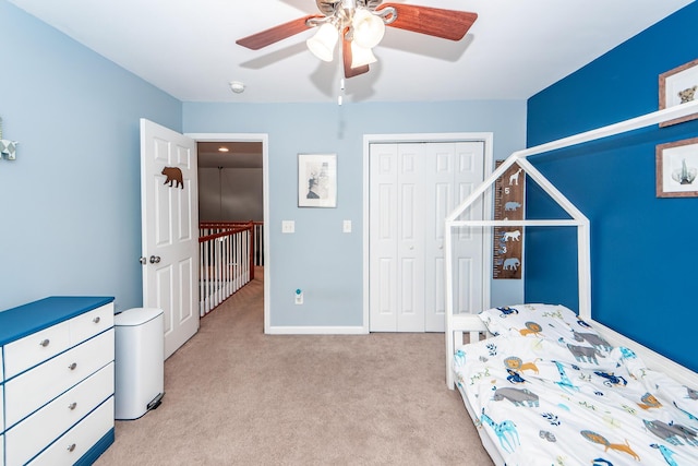 bedroom with a closet, light colored carpet, and ceiling fan