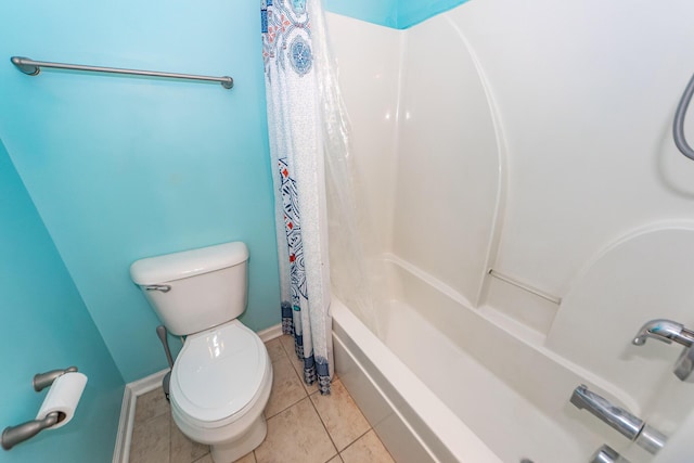 bathroom featuring tile patterned flooring, shower / tub combo, and toilet