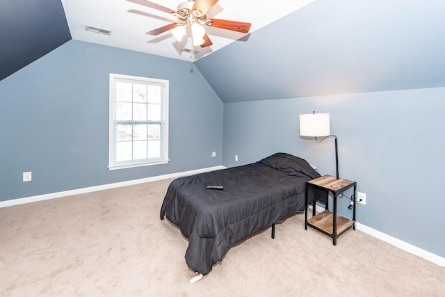 bedroom with ceiling fan, light colored carpet, and lofted ceiling