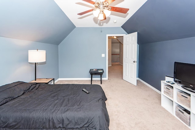 bedroom with ceiling fan, light colored carpet, and vaulted ceiling