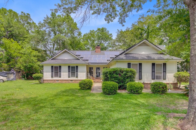 4 Garth Dr, Charleston, SC 29414 - view of front of house with roof with shingles, a front yard, solar panels, and french doors