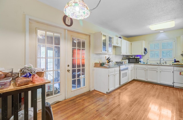 4 Garth Dr, Charleston, SC 29414 - kitchen featuring white gas range, a sink, dishwasher, light wood-style flooring, and a textured ceiling