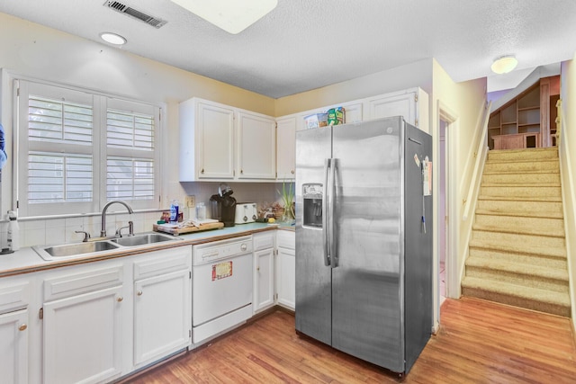 4 Garth Dr, Charleston, SC 29414 - kitchen with stainless steel refrigerator with ice dispenser, white dishwasher, a sink, white cabinetry, and light wood finished floors