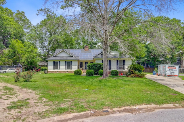 4 Garth Dr, Charleston, SC 29414 - ranch-style house with concrete driveway, roof mounted solar panels, a front yard, a chimney, and roof with shingles