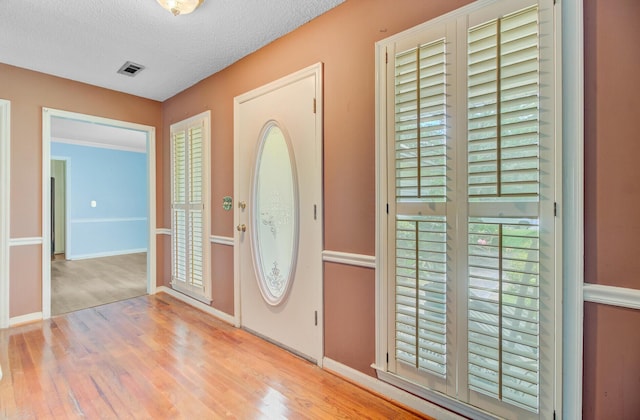 4 Garth Dr, Charleston, SC 29414 - entryway featuring wood finished floors, a textured ceiling, baseboards, and healthy amount of natural light