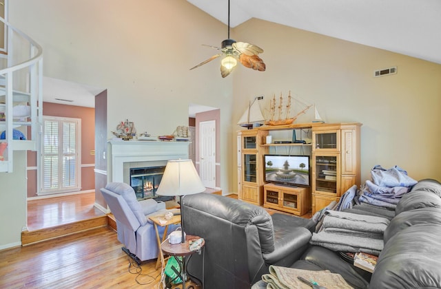 4 Garth Dr, Charleston, SC 29414 - living area featuring high vaulted ceiling, light wood-type flooring, ceiling fan, a glass covered fireplace, and baseboards