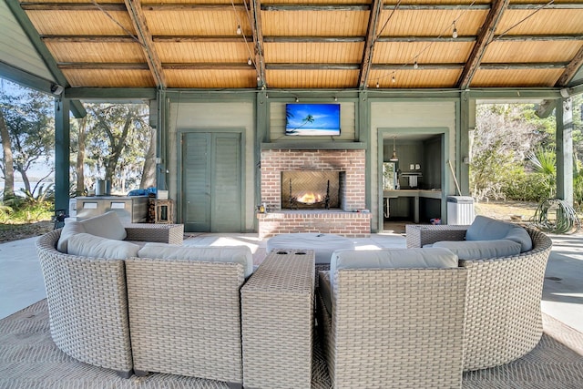 view of patio featuring an outdoor living space with a fireplace