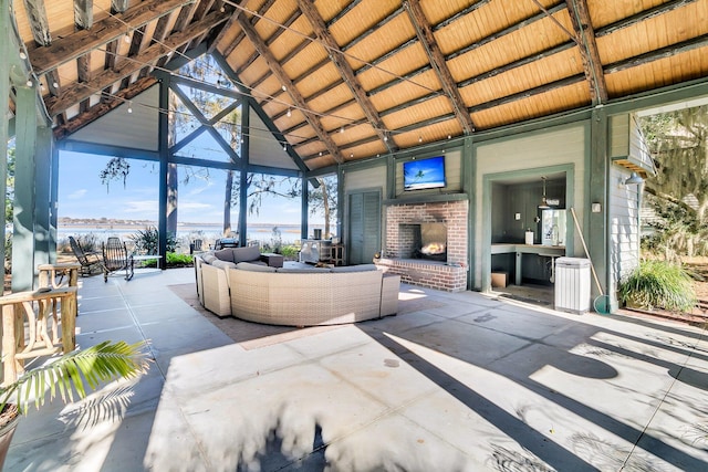 view of patio featuring an outdoor living space with a fireplace and a gazebo