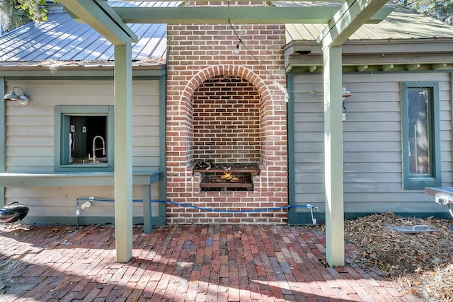 view of exterior entry with a patio