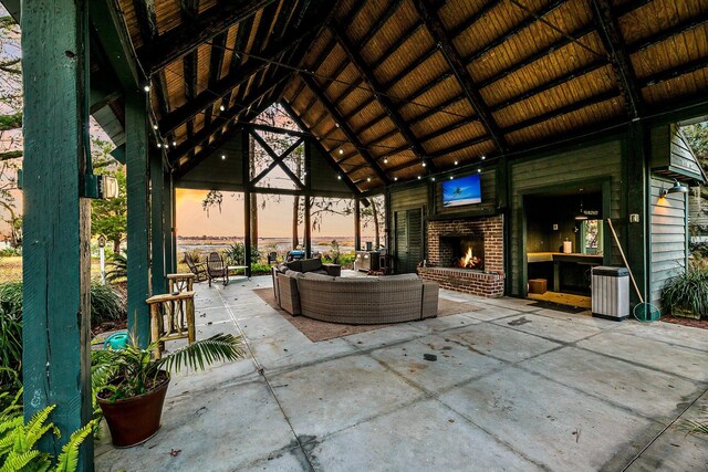 view of patio / terrace featuring a gazebo and an outdoor living space with a fireplace