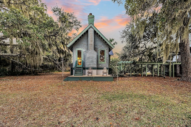 view of back house at dusk