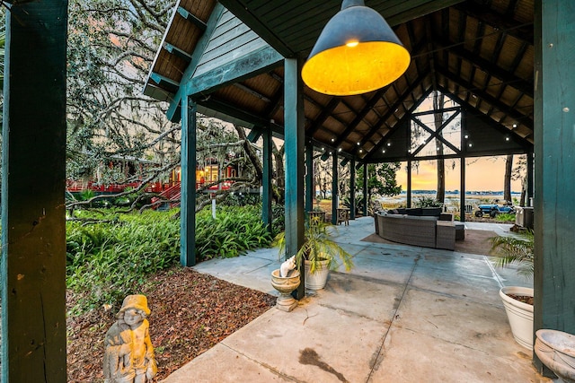 patio terrace at dusk featuring a gazebo and an outdoor living space