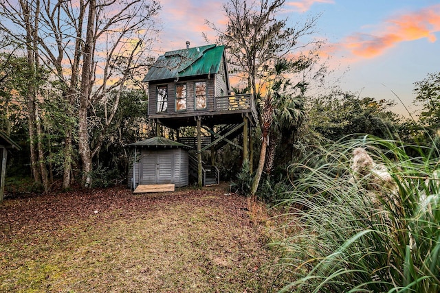 back house at dusk with a deck