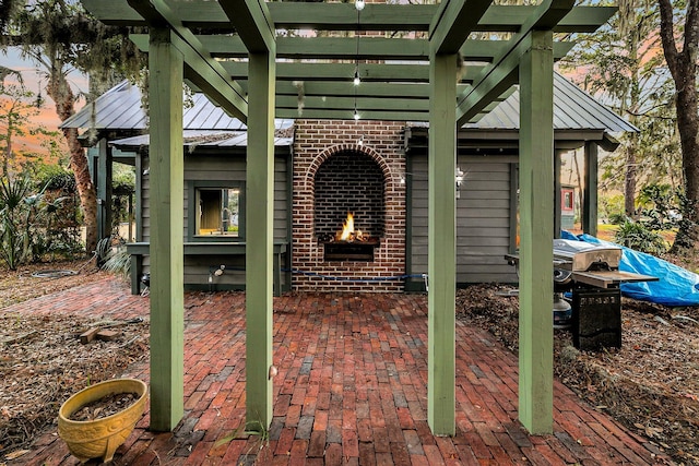 patio terrace at dusk featuring an outdoor brick fireplace