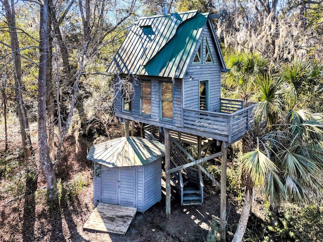 rear view of house featuring a wooden deck