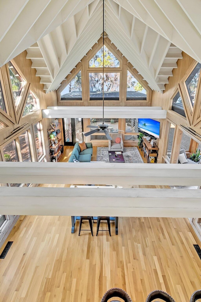 living room featuring lofted ceiling with beams and hardwood / wood-style flooring