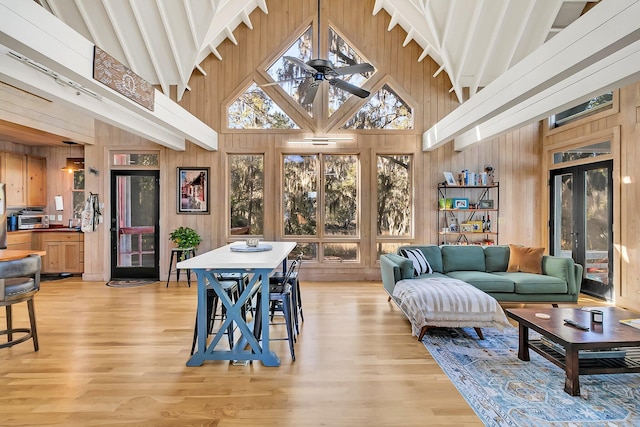 sunroom with ceiling fan and lofted ceiling