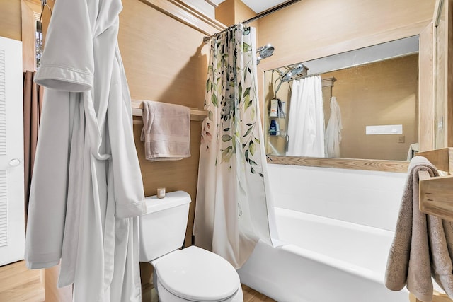 bathroom featuring shower / bath combination with curtain and toilet