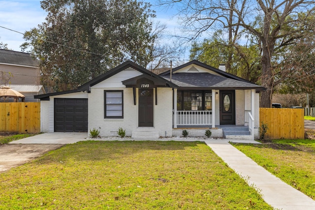 view of front of property with covered porch, a front lawn, concrete driveway, and brick siding