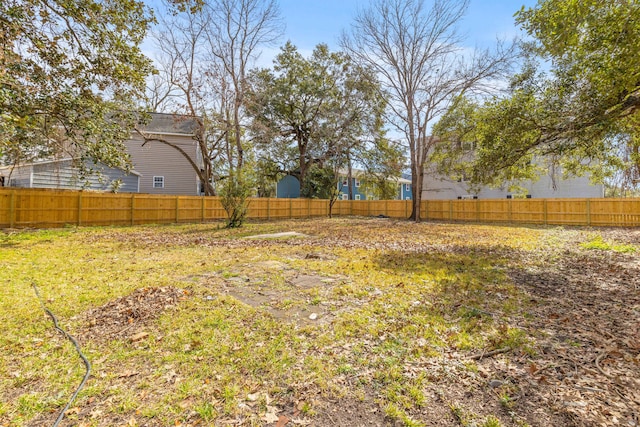 view of yard with a fenced backyard