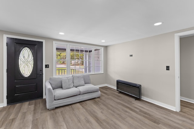 foyer entrance featuring light wood-style floors, recessed lighting, and baseboards