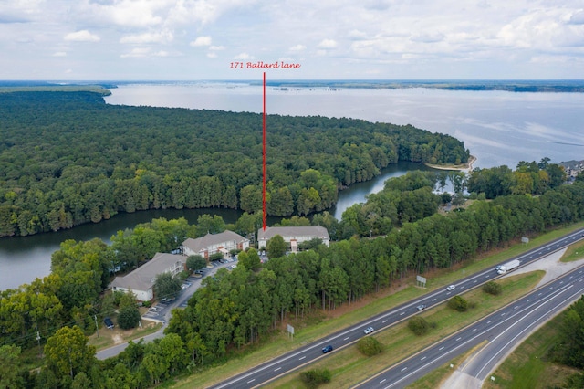 aerial view featuring a forest view and a water view