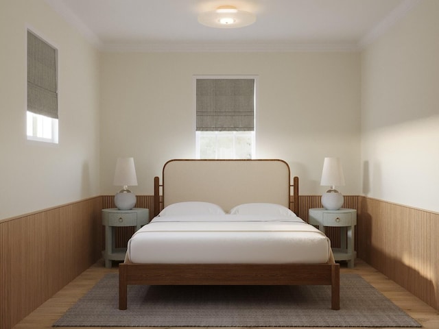 bedroom with light wood-type flooring and ornamental molding