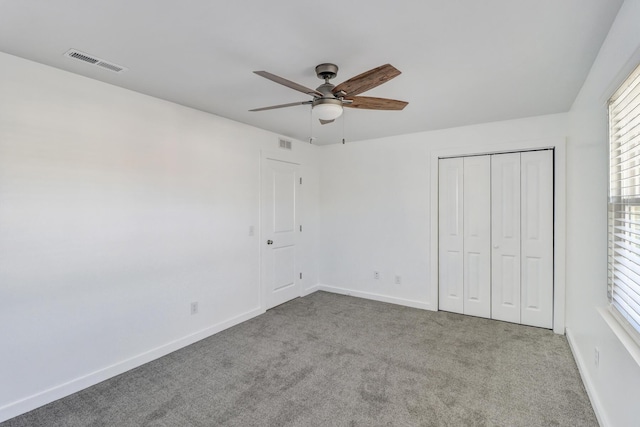 unfurnished bedroom featuring visible vents, carpet flooring, and baseboards